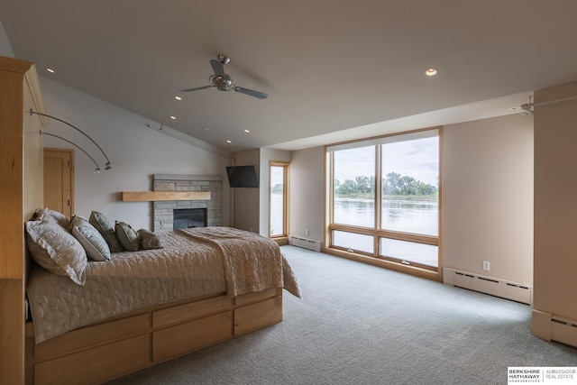 bedroom with a baseboard heating unit, recessed lighting, carpet, a fireplace, and lofted ceiling