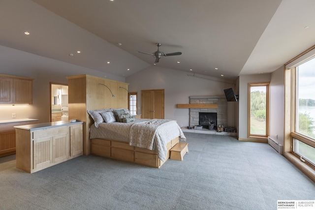 bedroom with lofted ceiling, recessed lighting, a stone fireplace, light colored carpet, and baseboard heating