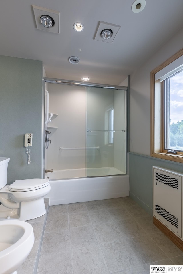 full bath with tile patterned flooring, toilet, recessed lighting, shower / bath combination with glass door, and heating unit