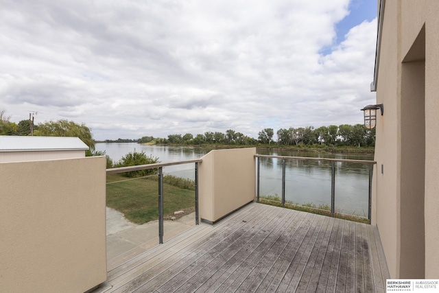 wooden terrace featuring a water view