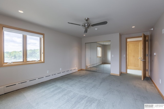 unfurnished bedroom with recessed lighting, carpet, baseboards, and a baseboard radiator