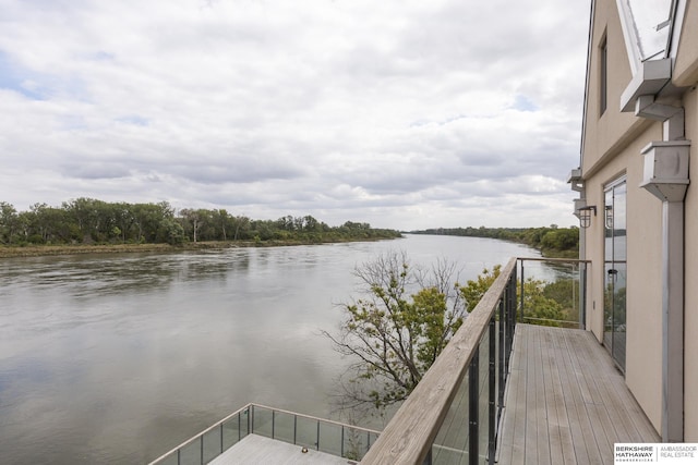 view of dock with a water view and a balcony