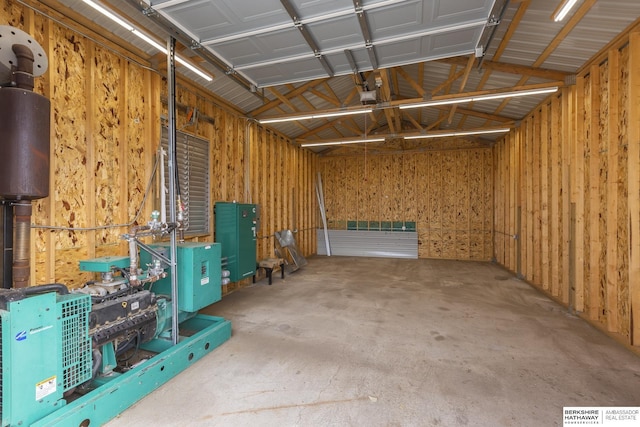 garage with visible vents, a garage door opener, and metal wall