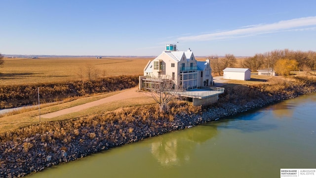 exterior space with a rural view and a water view