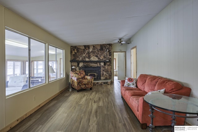 living room with a fireplace and wood finished floors