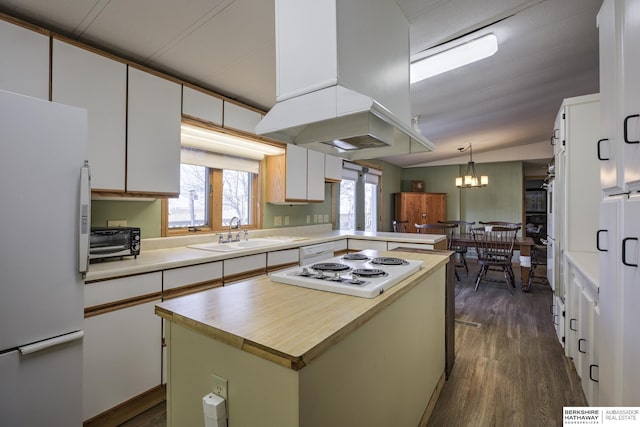 kitchen with dark wood-type flooring, island exhaust hood, white appliances, white cabinetry, and a sink