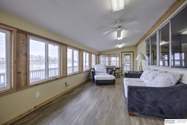 sunroom / solarium with a ceiling fan and lofted ceiling