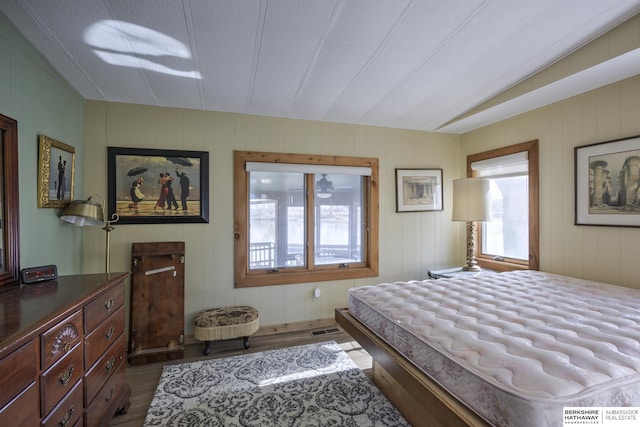 bedroom with visible vents and wood finished floors