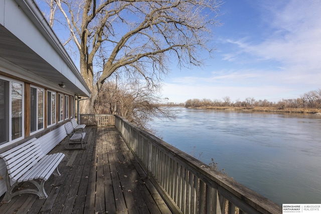 wooden deck featuring a water view