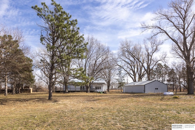 view of yard featuring an outbuilding and a pole building