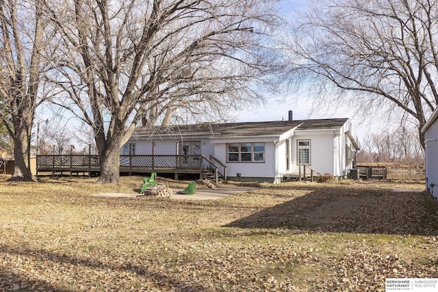 rear view of house with a wooden deck and central AC