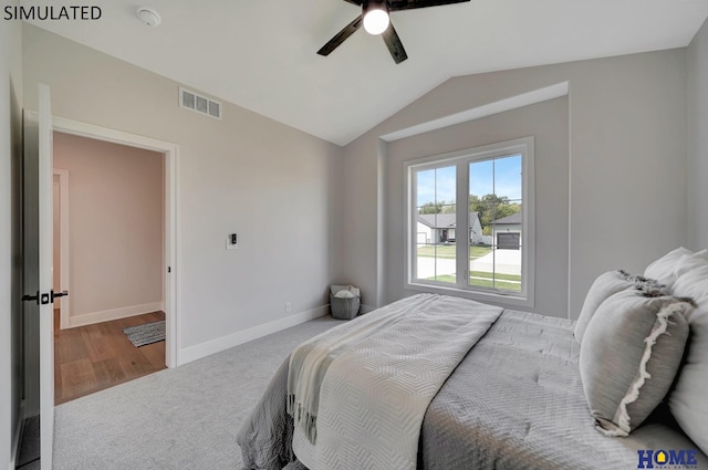 bedroom with baseboards, visible vents, lofted ceiling, ceiling fan, and carpet flooring