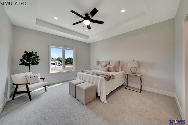 bedroom with a tray ceiling, recessed lighting, light colored carpet, and baseboards