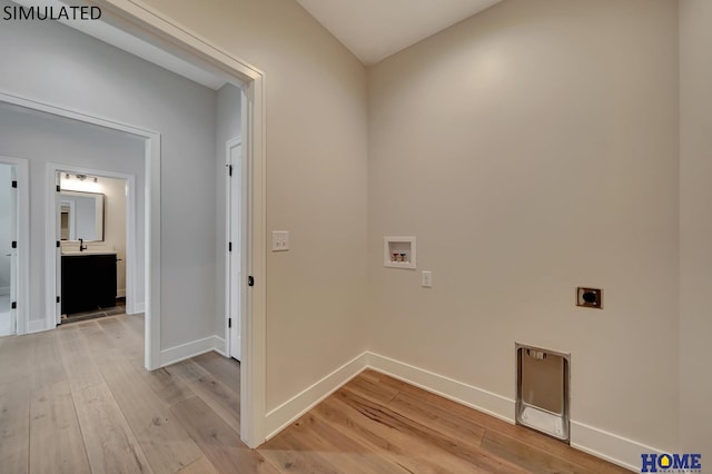 laundry room with light wood finished floors, baseboards, hookup for an electric dryer, hookup for a washing machine, and laundry area