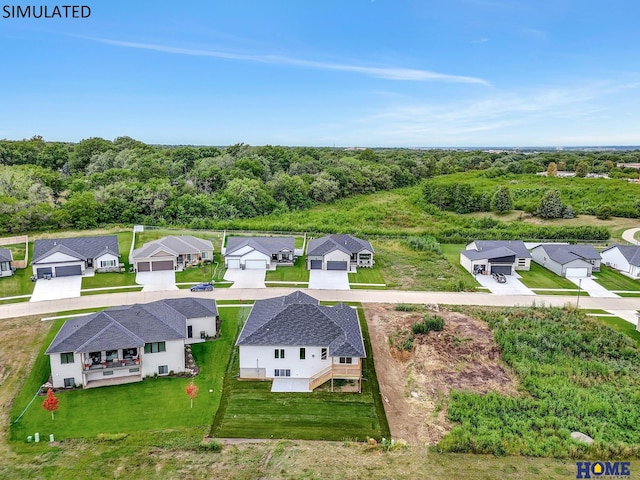 drone / aerial view featuring a residential view and a view of trees