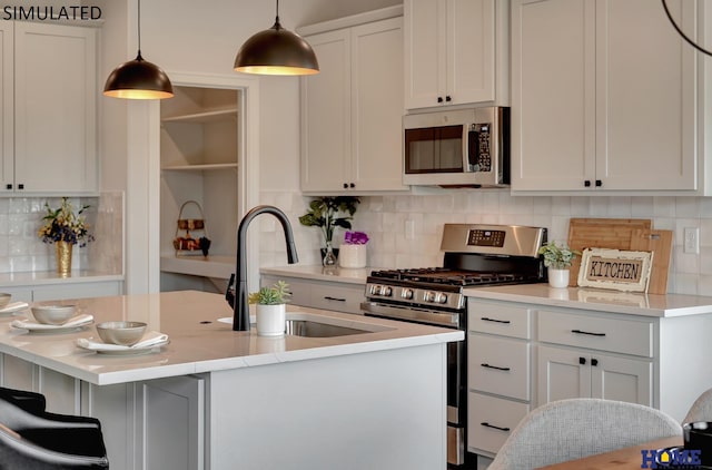 kitchen featuring light countertops, decorative backsplash, hanging light fixtures, stainless steel appliances, and a sink