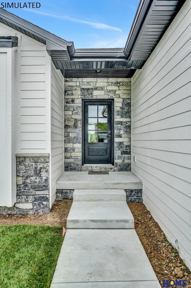 property entrance with stone siding and covered porch