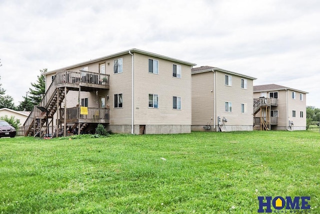 back of house with stairway, a wooden deck, and a yard