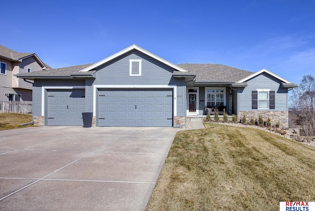 single story home with a garage, stone siding, a front yard, and driveway