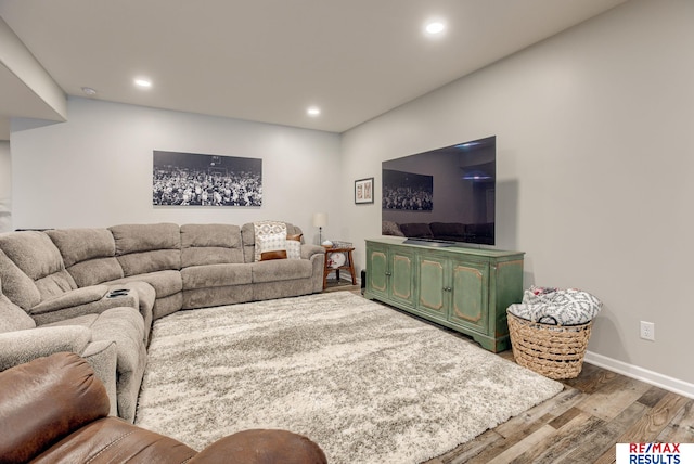 living area with recessed lighting, baseboards, and wood finished floors