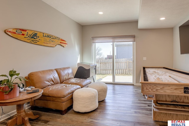 living area featuring recessed lighting, baseboards, and wood finished floors