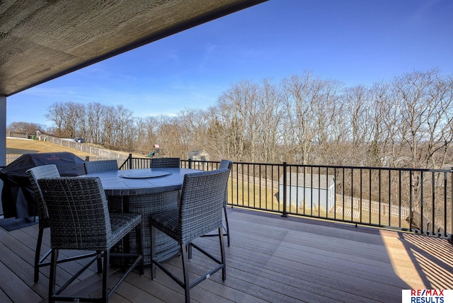 wooden terrace with outdoor dining space