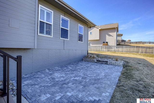 view of patio featuring fence