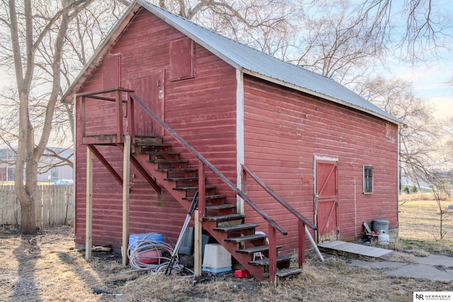 view of barn with fence