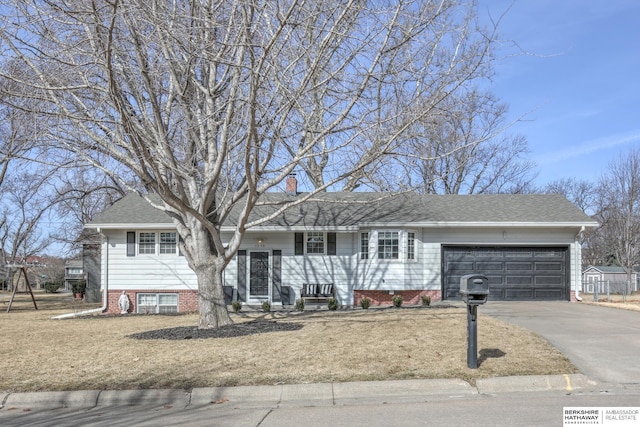 ranch-style house featuring a garage, roof with shingles, a chimney, and driveway