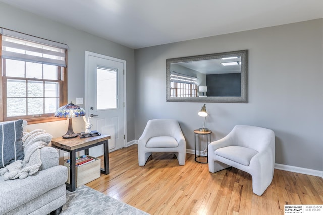 living area featuring baseboards and wood finished floors