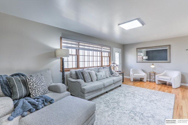 living room featuring baseboards and wood finished floors