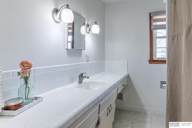 full bathroom featuring tile patterned floors, visible vents, vanity, and baseboards