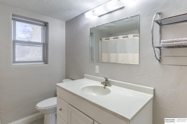 full bath featuring toilet and vanity