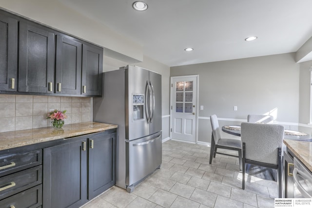 kitchen with tasteful backsplash, recessed lighting, stainless steel appliances, light tile patterned floors, and baseboards