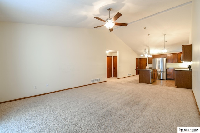 unfurnished living room featuring visible vents, light colored carpet, ceiling fan with notable chandelier, and baseboards