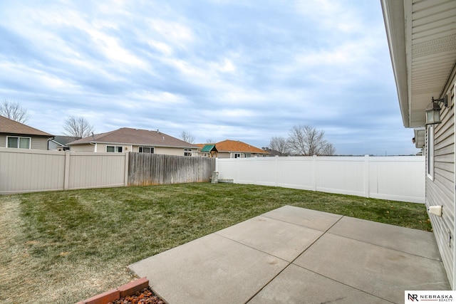 view of yard with a patio area and a fenced backyard