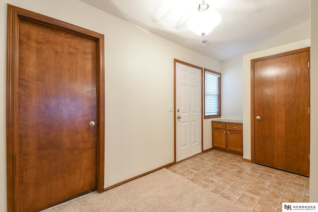 entrance foyer with light carpet, visible vents, and baseboards