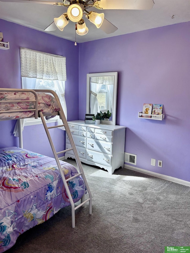 carpeted bedroom featuring visible vents, baseboards, and a ceiling fan