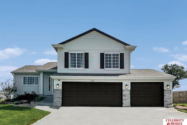 view of front of property with a garage, fence, stone siding, and driveway