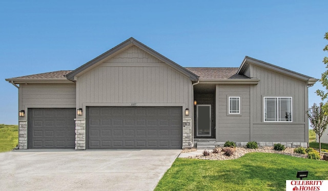 view of front of house with a front lawn, a garage, driveway, and roof with shingles