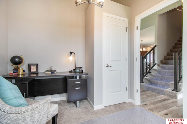 office with light wood-style floors, baseboards, and a chandelier