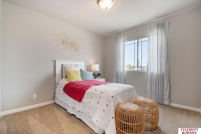 bedroom featuring carpet and baseboards