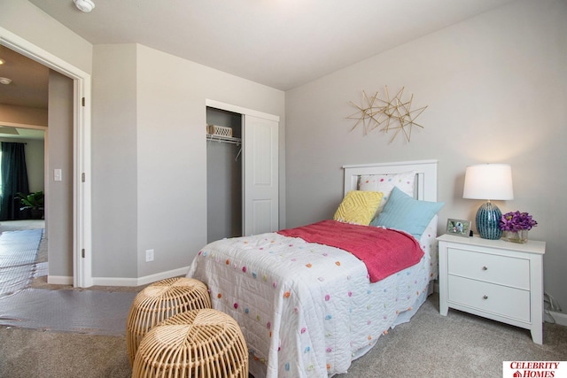 bedroom with carpet, a closet, and baseboards