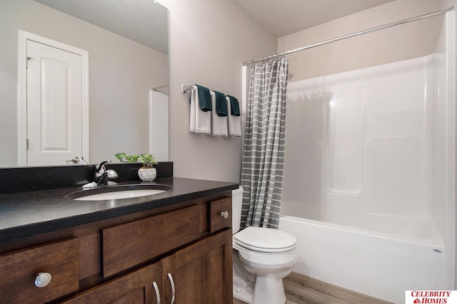 bathroom featuring shower / bath combo, toilet, vanity, and wood finished floors