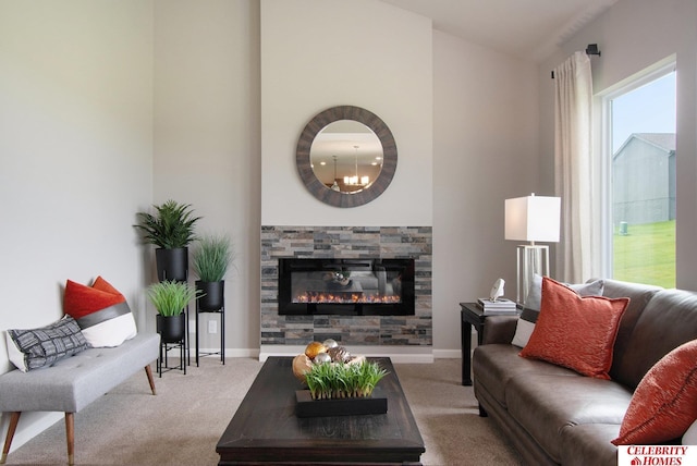 carpeted living room with baseboards and a glass covered fireplace