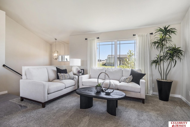 living room with baseboards, carpet floors, an inviting chandelier, and vaulted ceiling