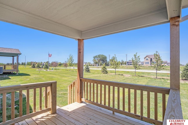 wooden terrace featuring a yard