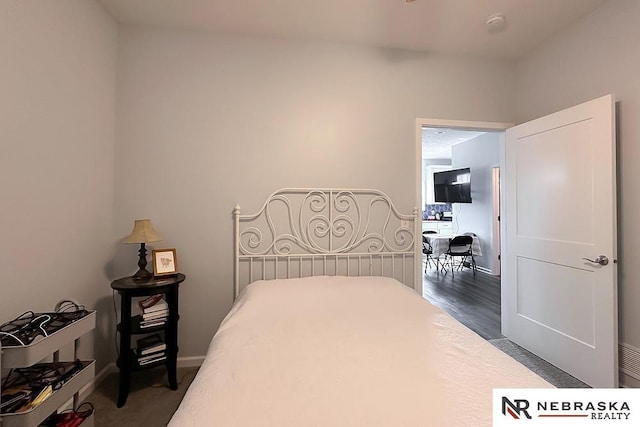 bedroom featuring baseboards and dark wood finished floors