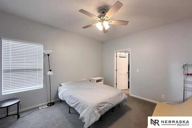 carpeted bedroom featuring a ceiling fan and baseboards