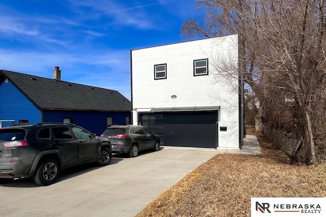 view of front of home featuring stucco siding, driveway, and an attached garage